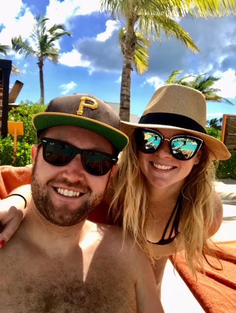Adam and BitesByBritt on a beach.