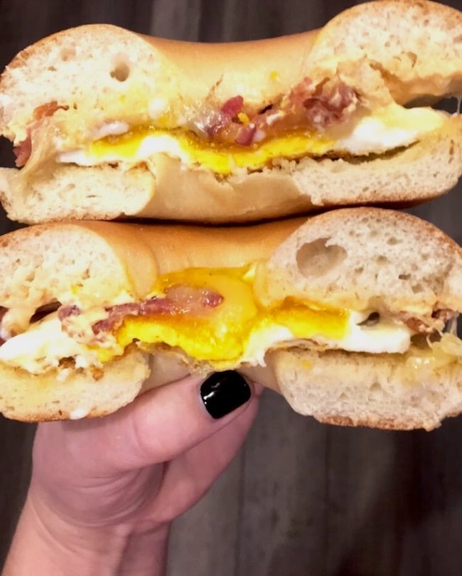 Bacon, egg, and cheese on a sliced bagel sandwich.
