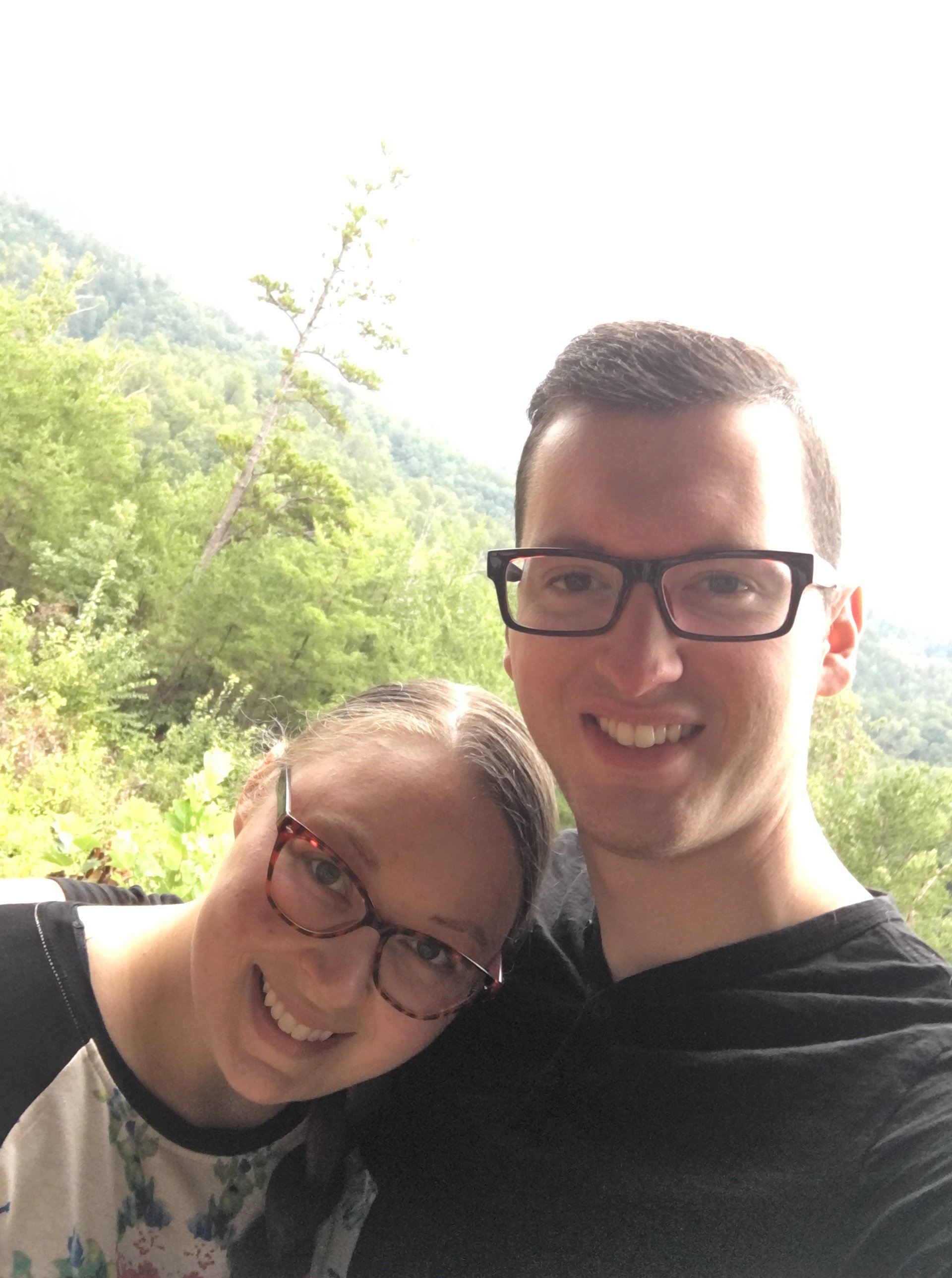 A selfie of "The Speedy Spatula" and her husband overlooking the top of a forest.