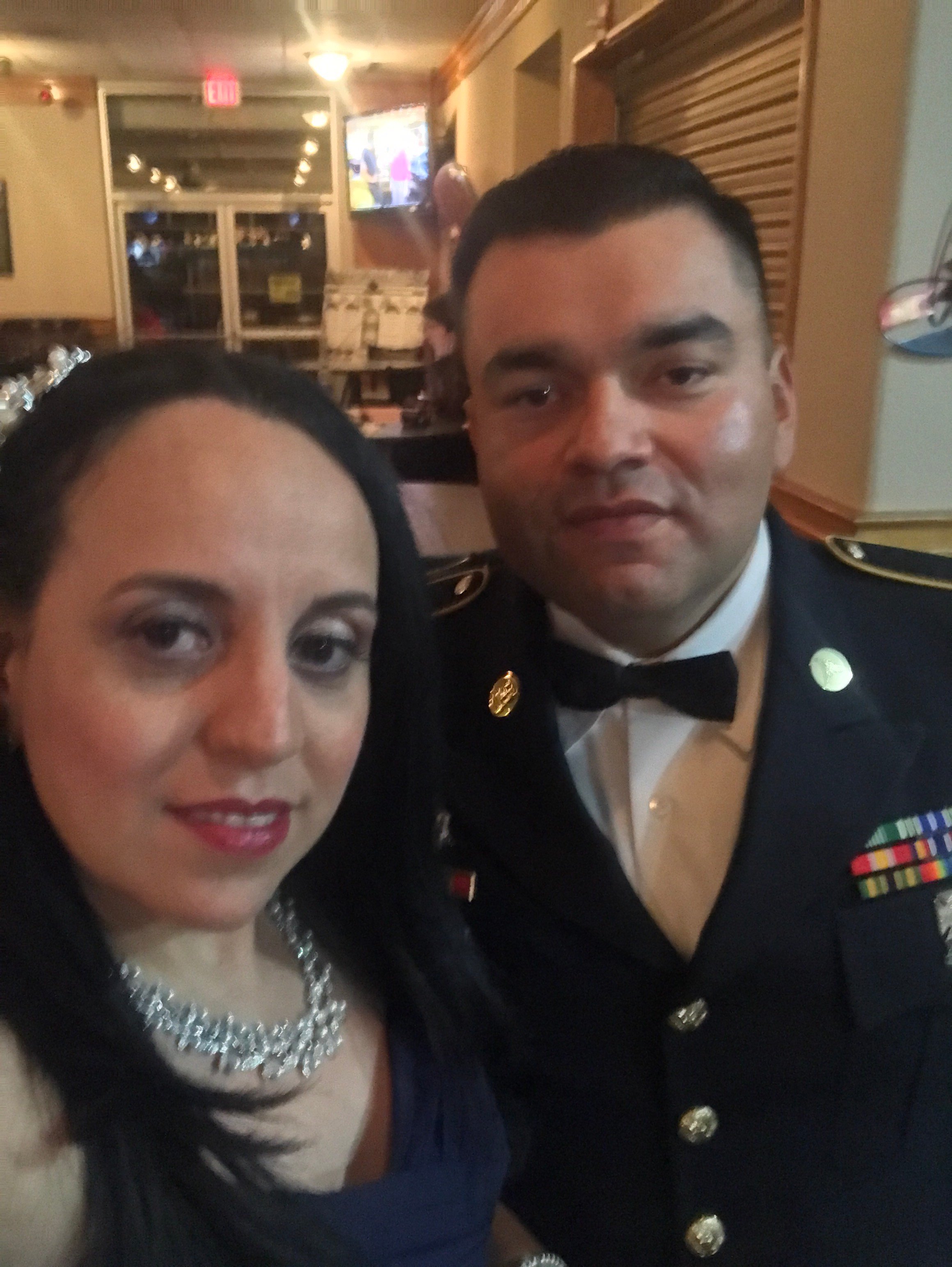 Cafesazonvidya and her husband, who is wearing a dress military uniform.