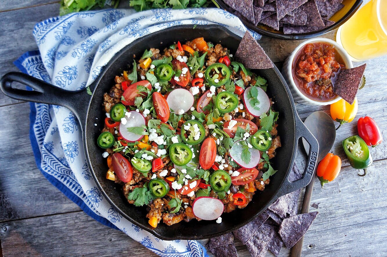 Taco ingredients in a cast iron skillet.