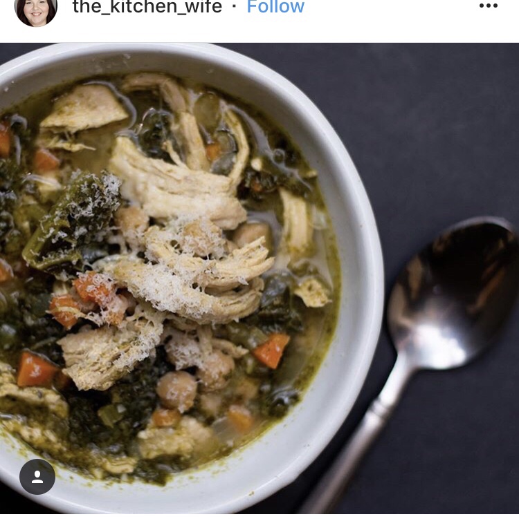 An Instagram post from the_kitchen_wife. It is a bowl of chicken and vegetable soup next to a spoon.