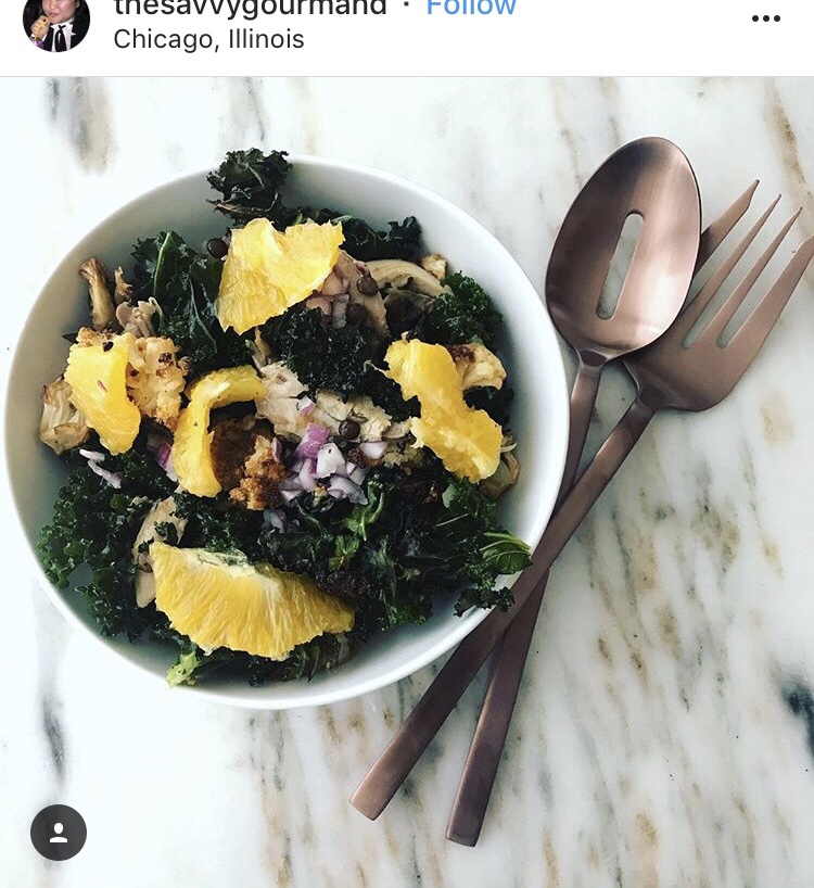 An Instagram post from thesavvygourmand in Chicago featuring a kale salad with citrus.