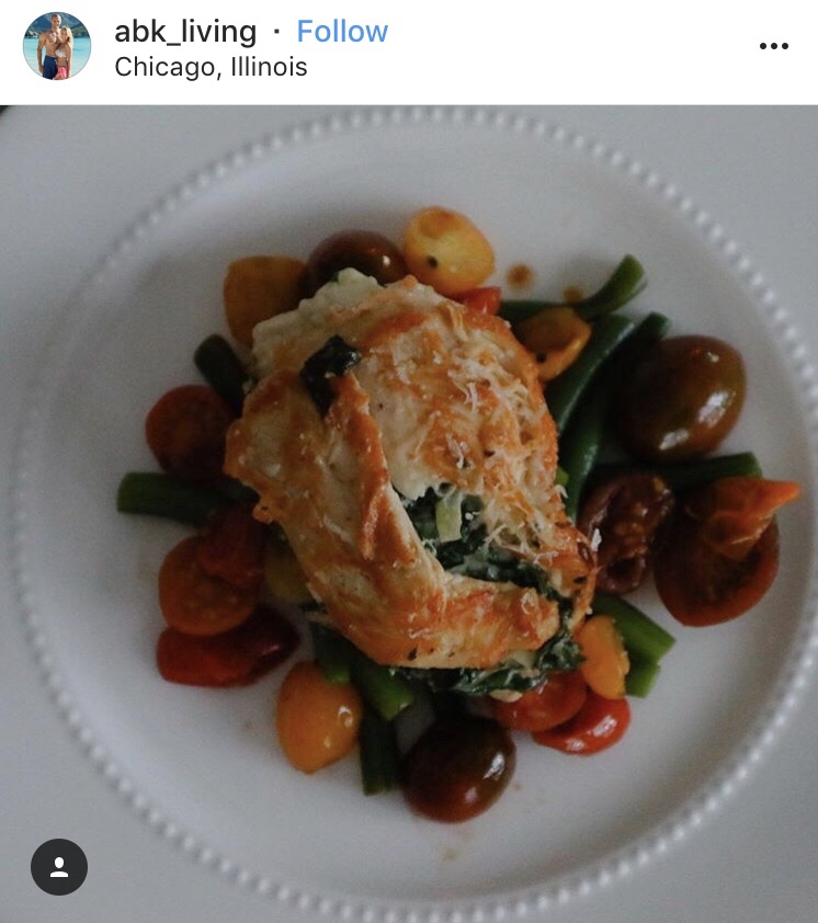 An Instagram post from abk_living in Chicago, Illinois featuring a stuffed chicken breast over sliced grape tomatoes and green beans.