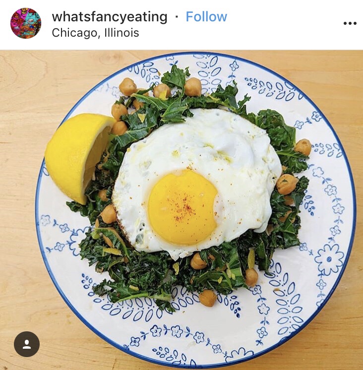 An Instagram post from whatsfancyeating in Chicago, Illinois with a sunny side egg on top of greens.