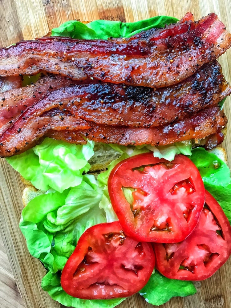 The BLT ingredients on two slices of sourdough bread.
