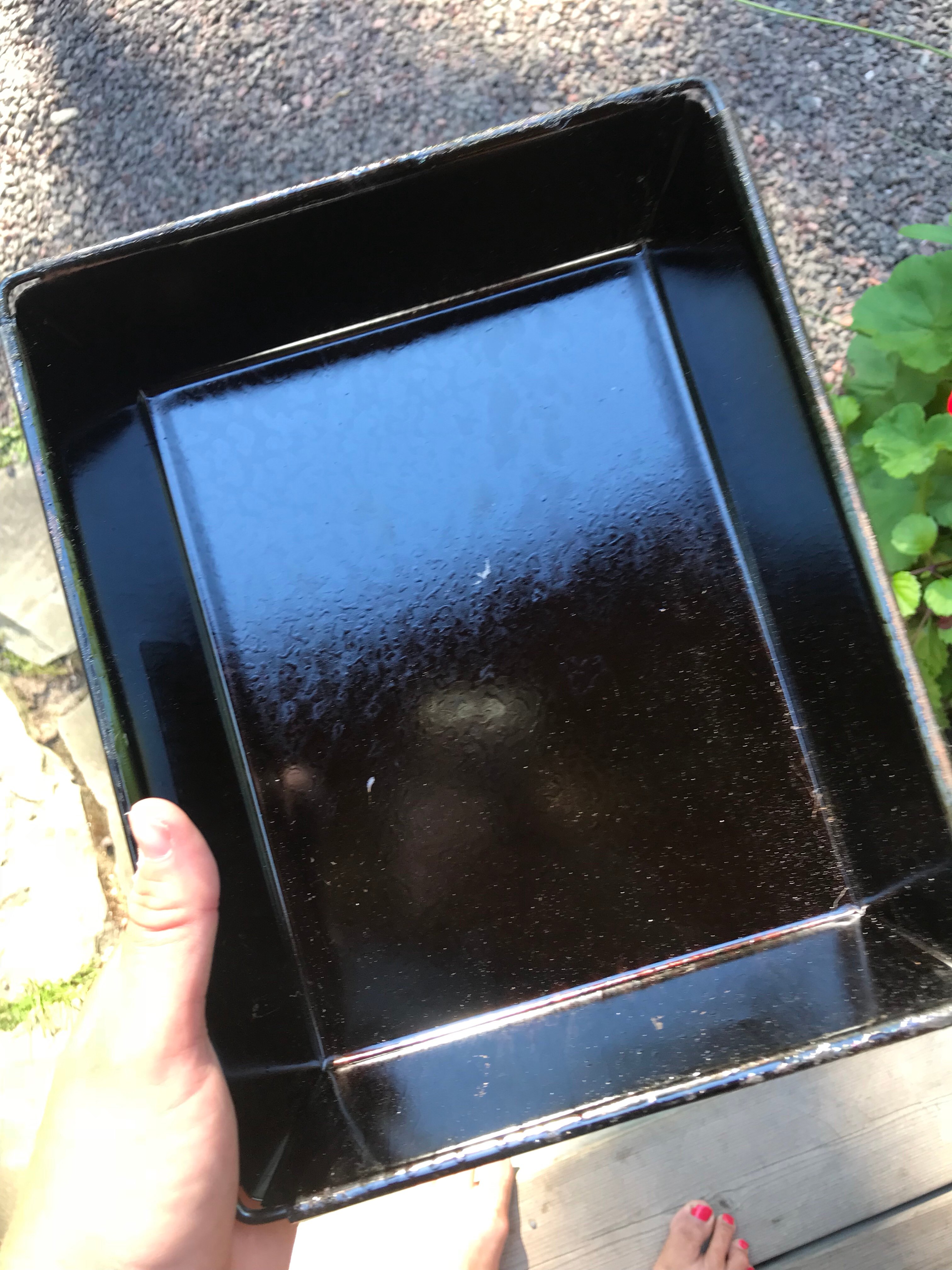 An empty blue steel square pizza pan.