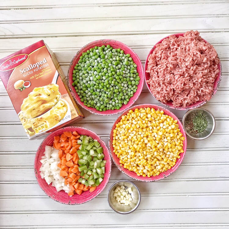Ground beef, corn, carrots, onions, celery, spices, and instant scalloped potatoes.