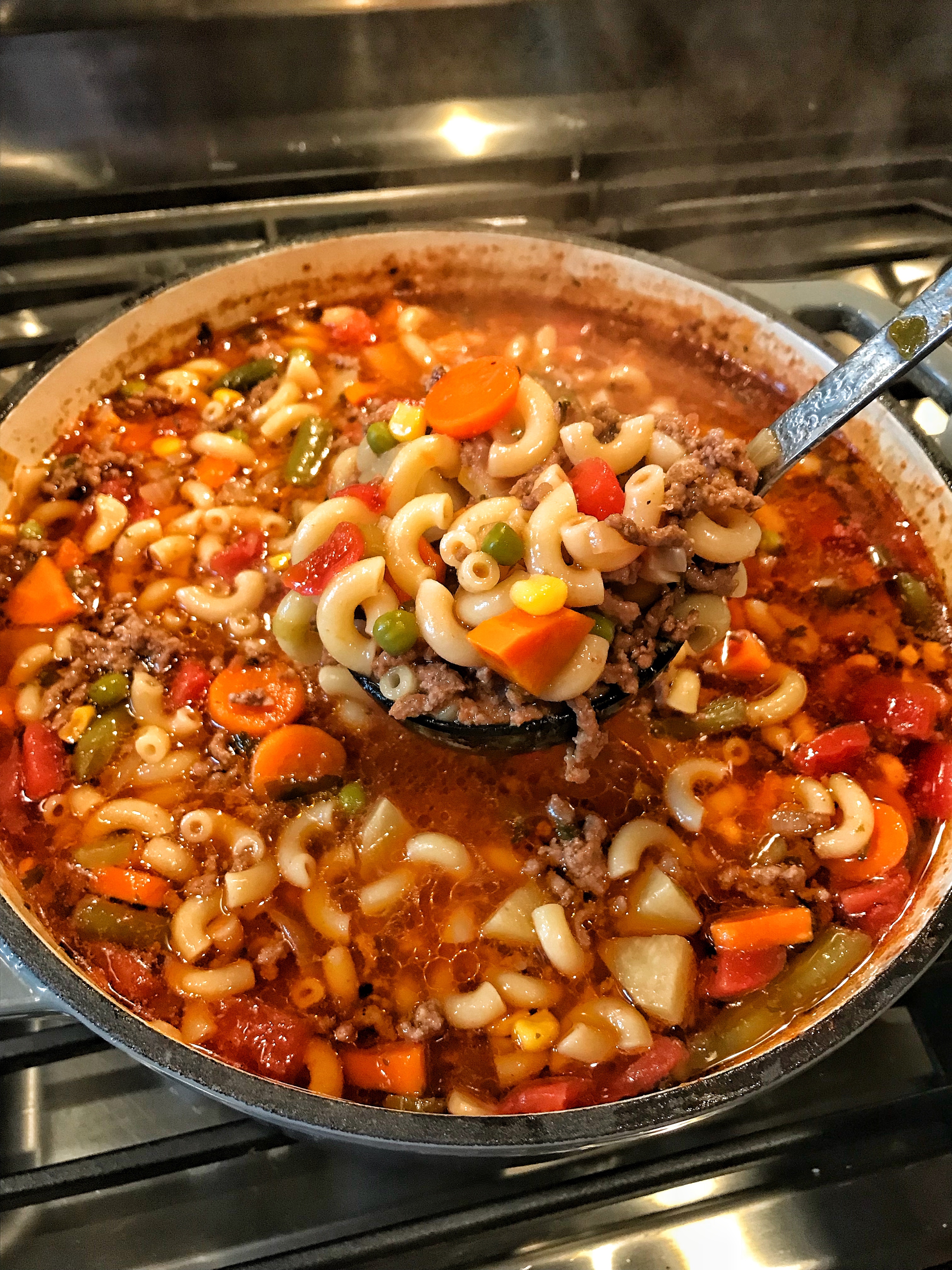 A ladle full of Hamburger and Macaroni soup