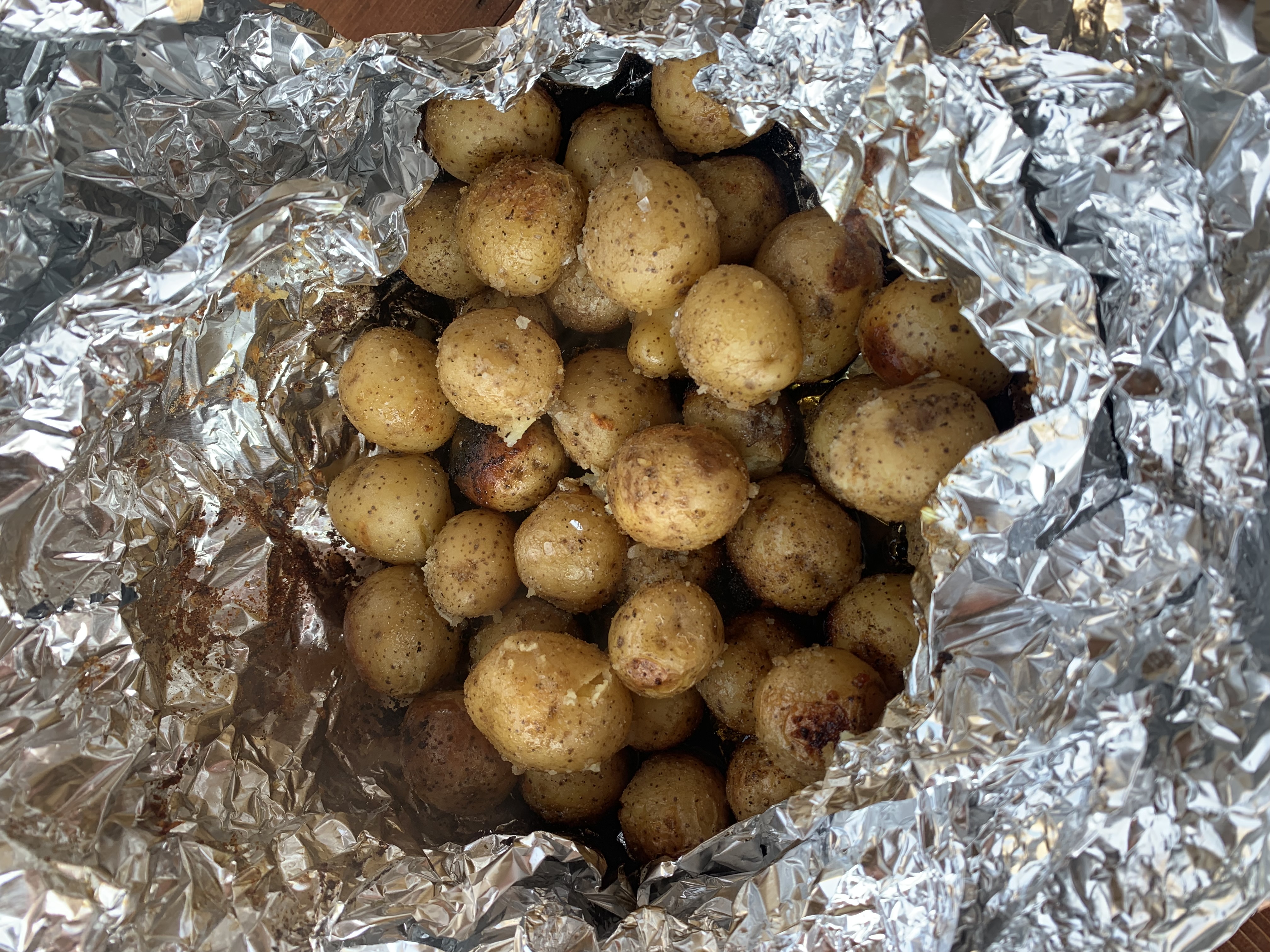 A bunch of baby potatoes in a tin foil bowl