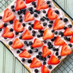 Picture of a cookie crust with cream cheese, strawberries, blue berries