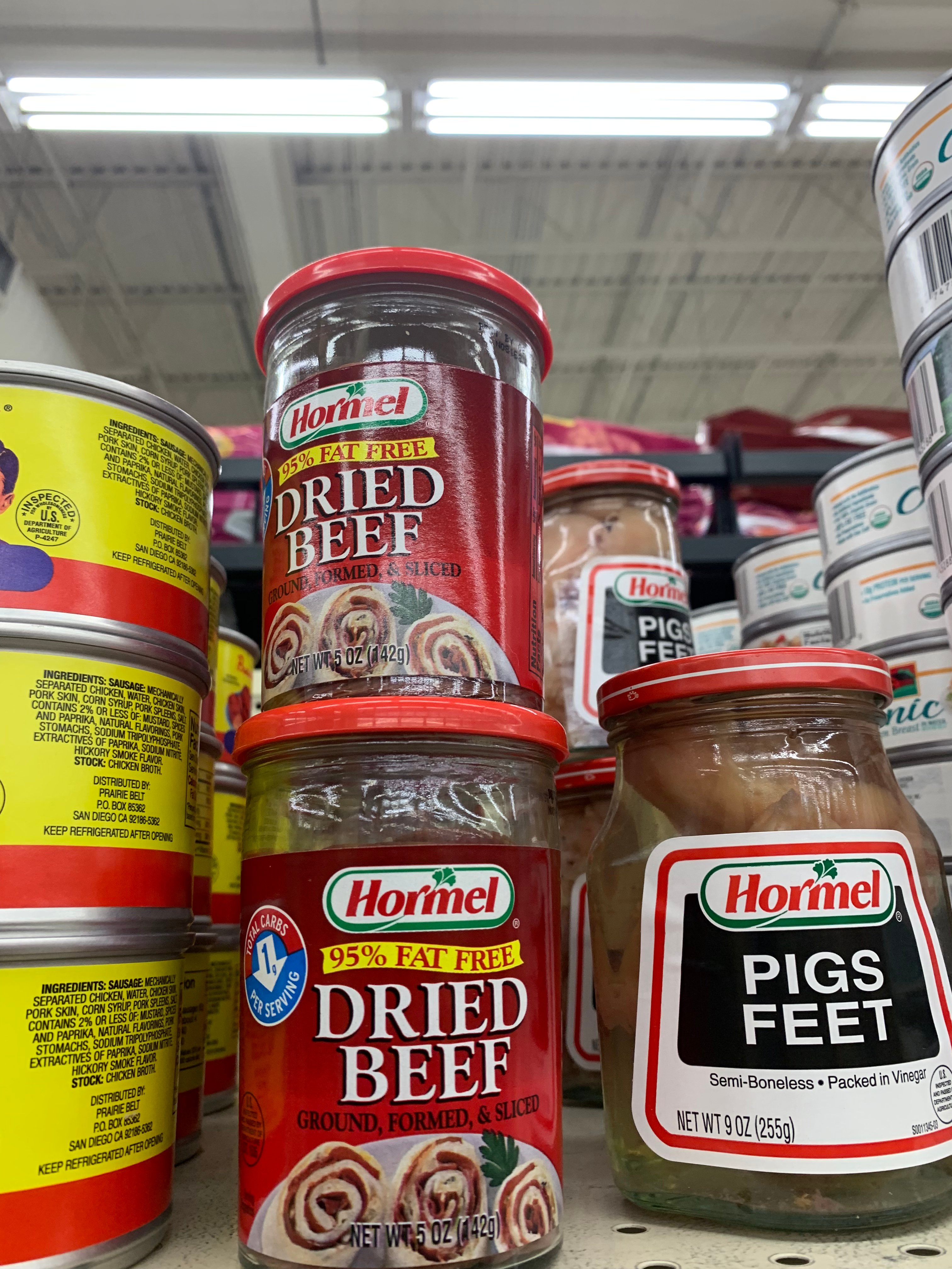 Jars of Hormel dried beef and pigs feet on a supermarket shelf