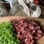 Diced dried beef and green onions about to be poured into the dip mixture.