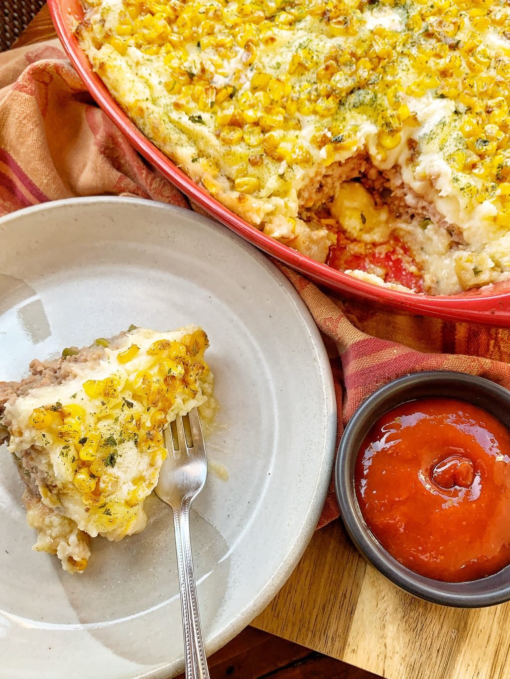 Meatloaf Casserole with whipped potatoes and corn served with ketchup
