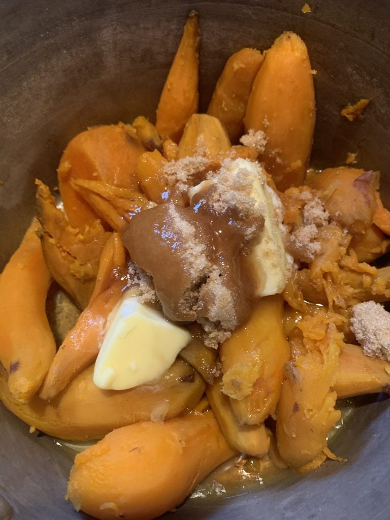 Sweet potatoes, butter, salt, and maple syrup in a pot