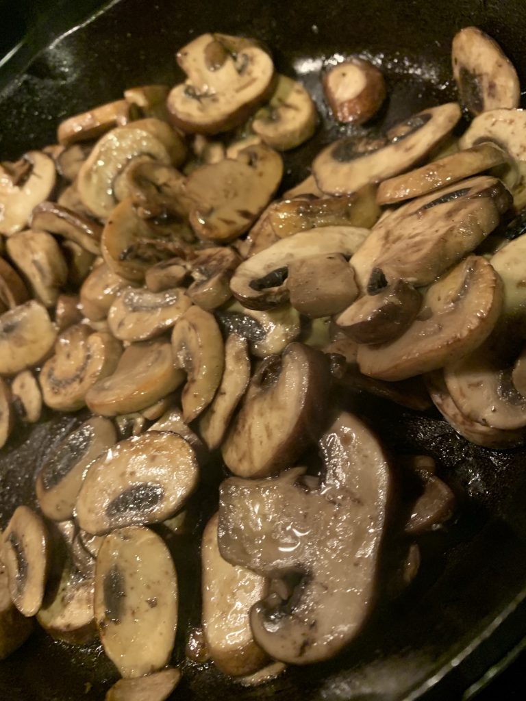 Mushrooms cooking in a pan