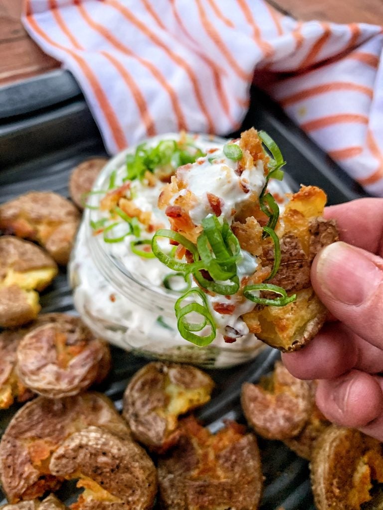 A party potato dipped in a bacon blue cheese dip