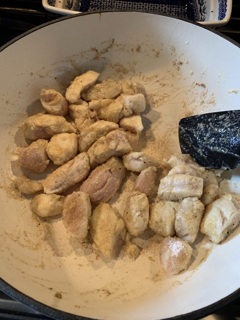 The chicken cooking in the pan