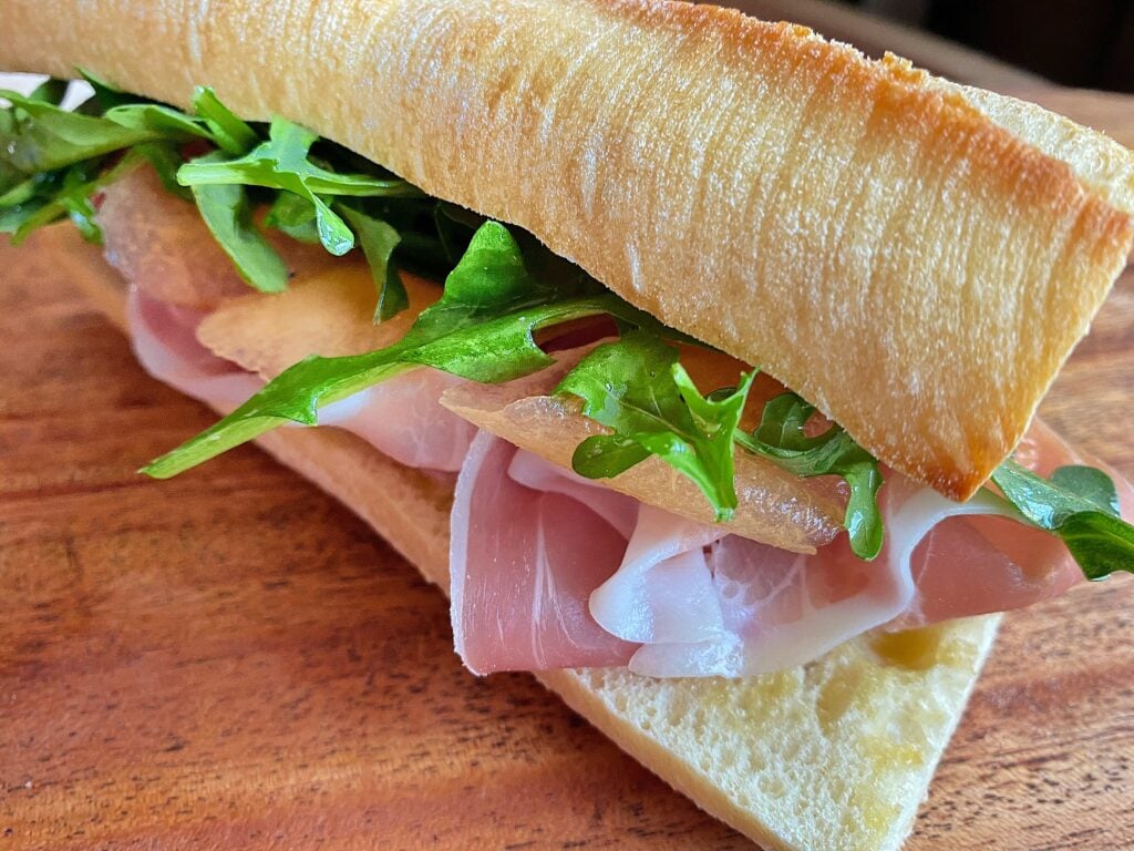 Prosciutto, arugula and cantaloup on a toasted baguette with butter