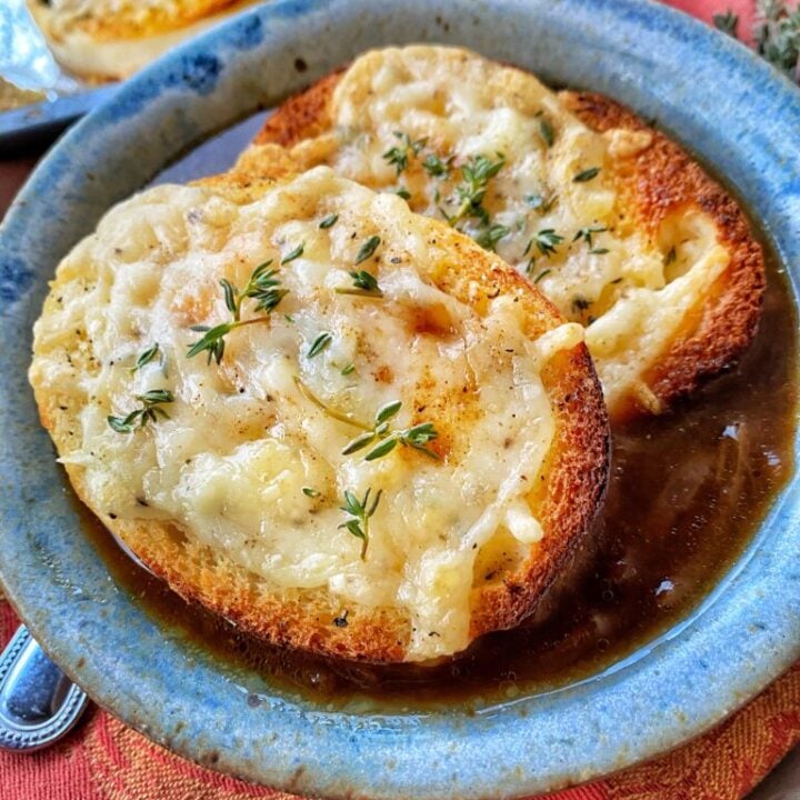A bowl of French Onion Soup with Cheesy toast bread rounds