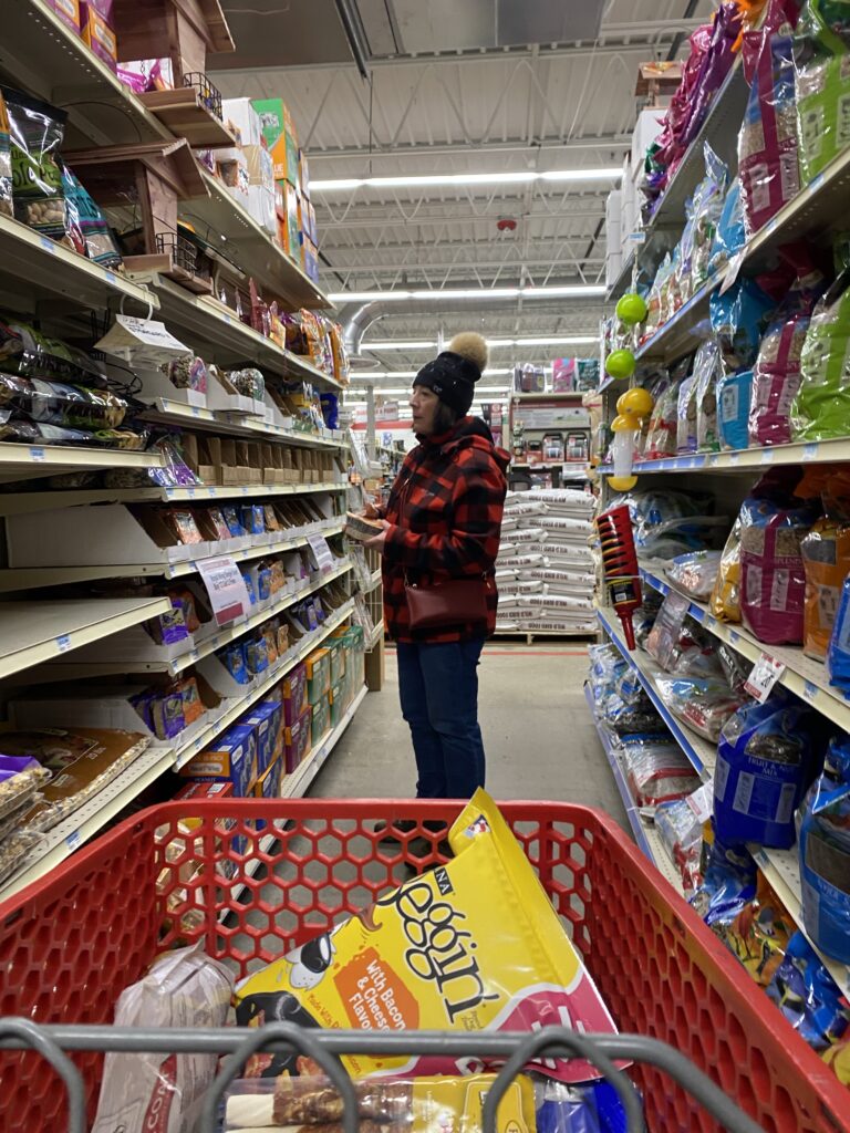 My mom in the shopping aisle of Tractor Supply