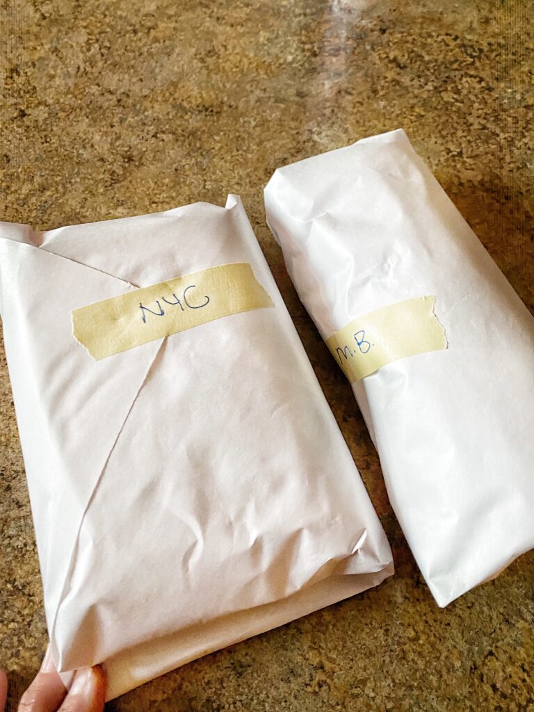 Two sandwiches wrapped in paper