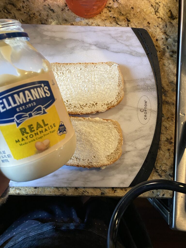 Two slice of bread with mayo spread on top