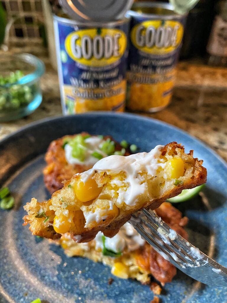 A corn fritter on a fork