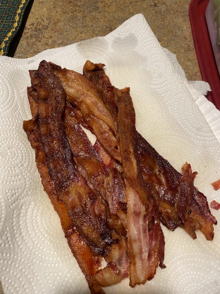Cooked bacon on a paper towel