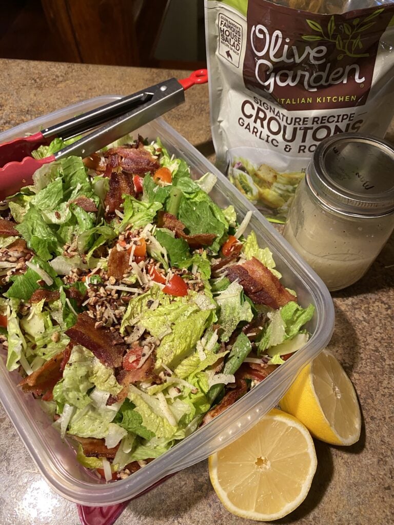 A salad made with romaine lettuce, crumbled bacon, cheese and tomato. Served with a lemon garlic vinaigrette and croutons