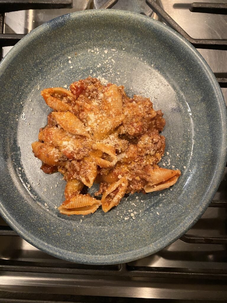 A plate of meat sauce and stuffed shells