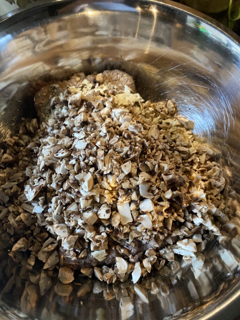 Diced mushrooms in a metal bowl