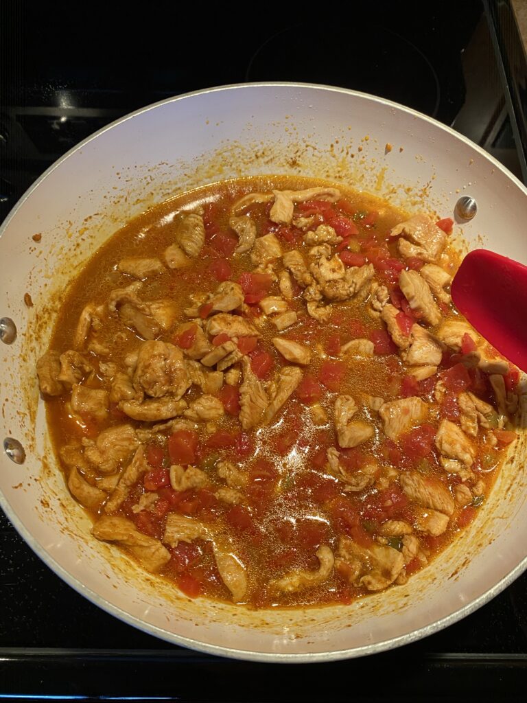 The chicken mixture cooking on the stove