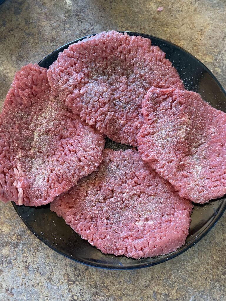 Cubed Steak seasoned up with garlic powder, onion powder and black pepper to make Easy Baked Steak with Savory Mushroom Gravy