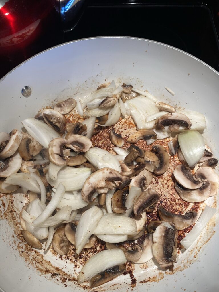 Mushrooms and onions in a pan