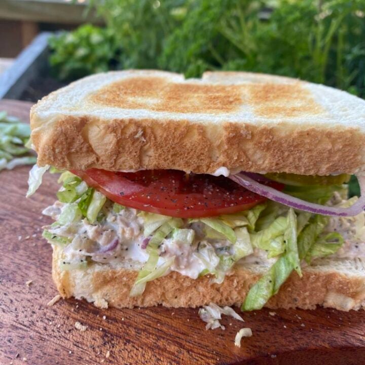 Tuna Salad Sandwich on toast with lettuce tomato onion and pickles