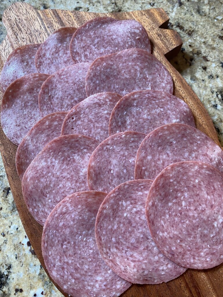 Salami layered on a cutting board