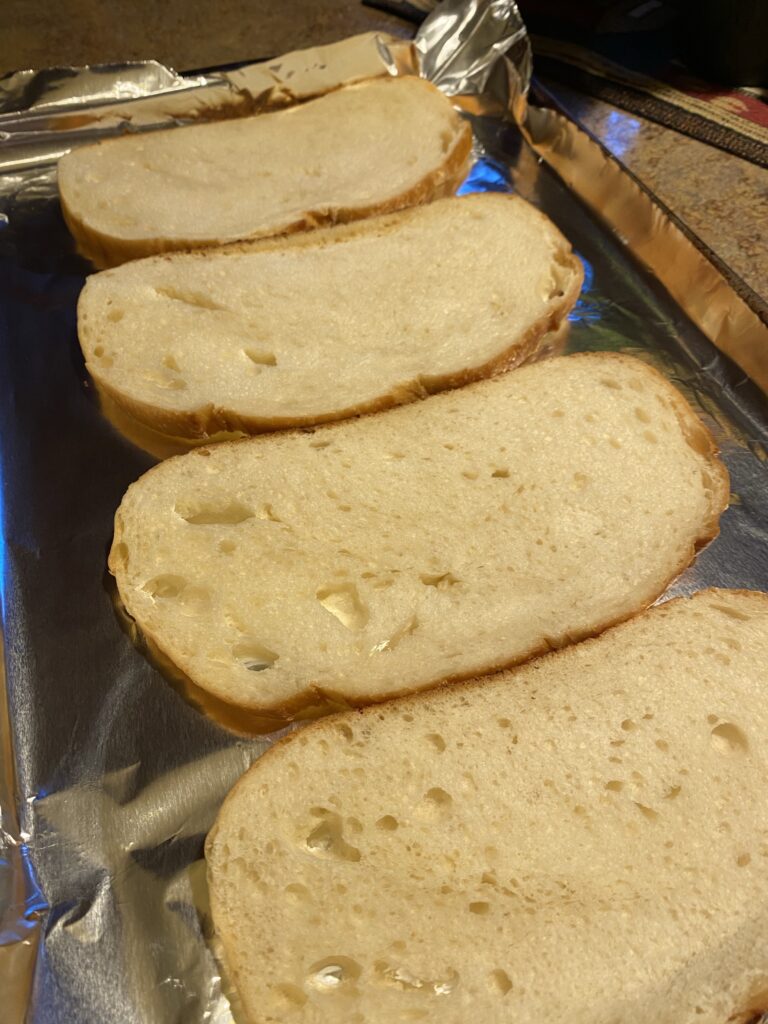 Slices of bread laid out on a baking dish