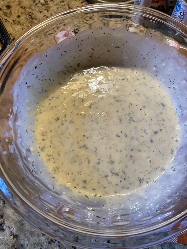 A glass bowl of creamy gravy