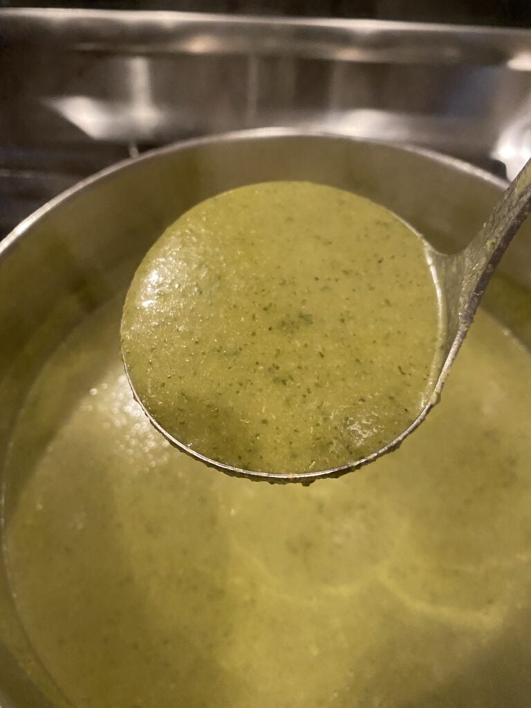 A ladle of broccoli asparagus soup