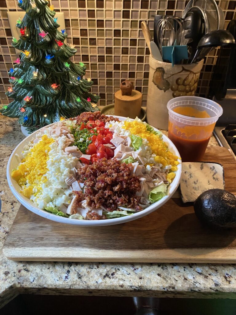 Cobb Salad in a bowl on a cutting board