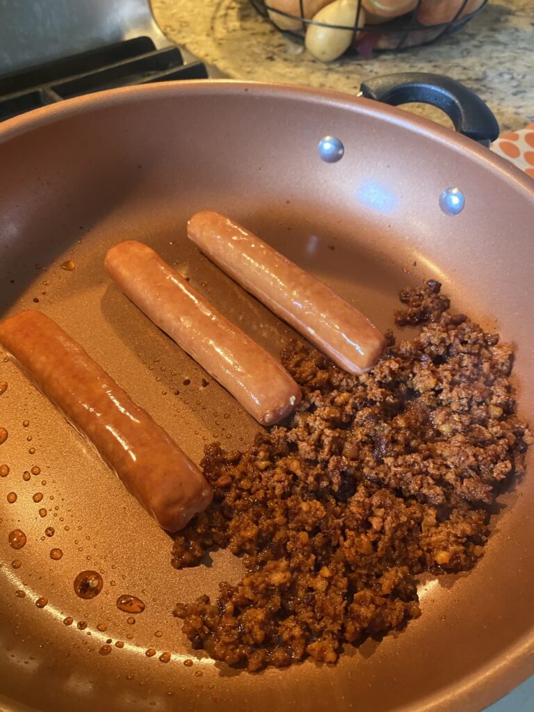 Sausages and chorizo cooking on the pan
