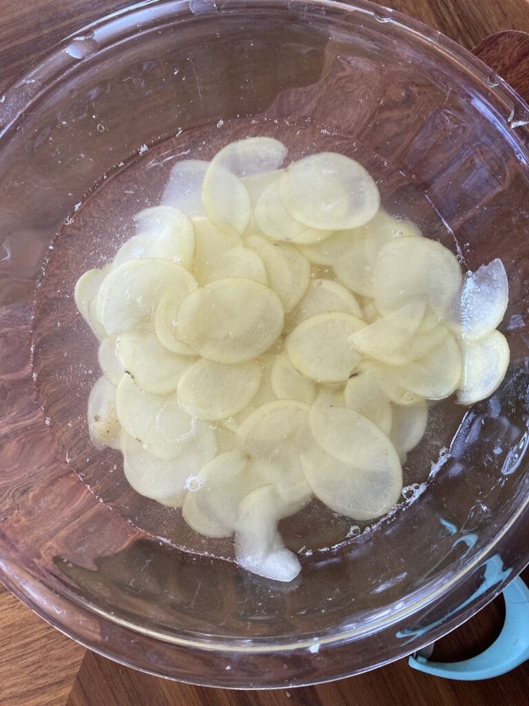Sliced potatoes soaking in water