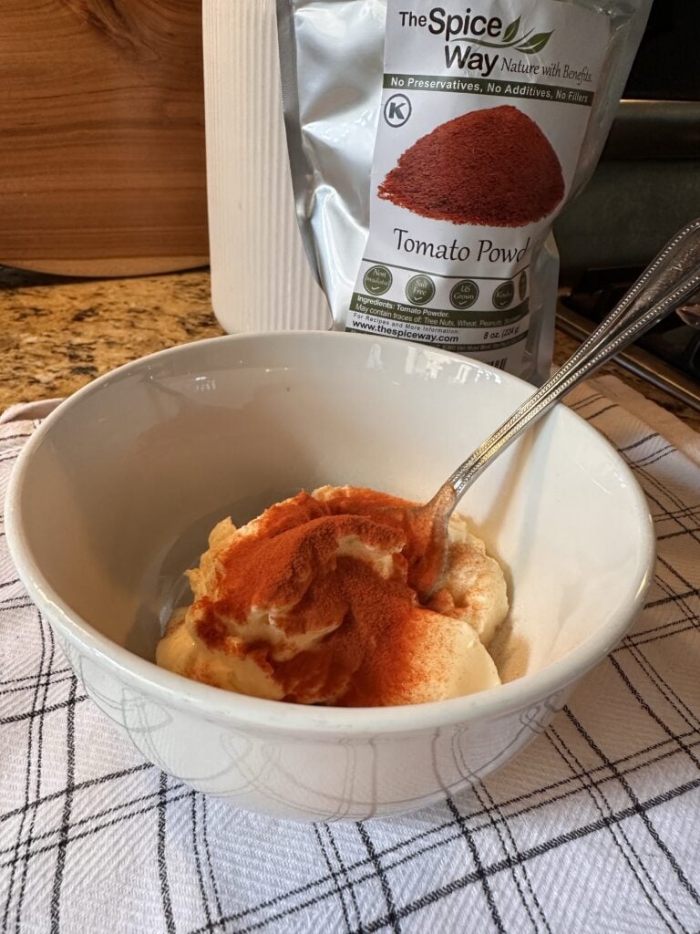 Mayo and tomato powder in a small bowl with a spoon