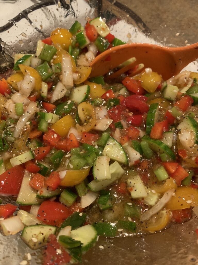 Chopped up veggies soaking in dressing