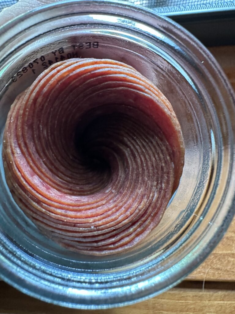 The jar of dried beef as seen from above, showing the beef slices are packaged in a cyclone pattern
