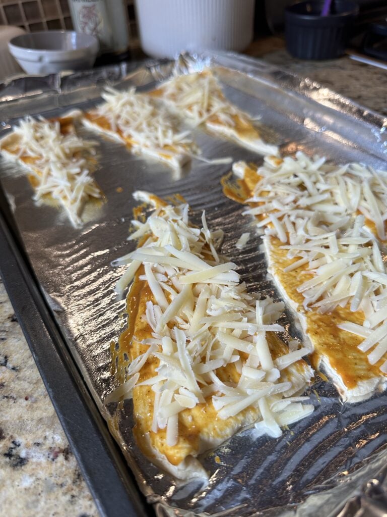Shredded cheese on top of crescent dough triangles