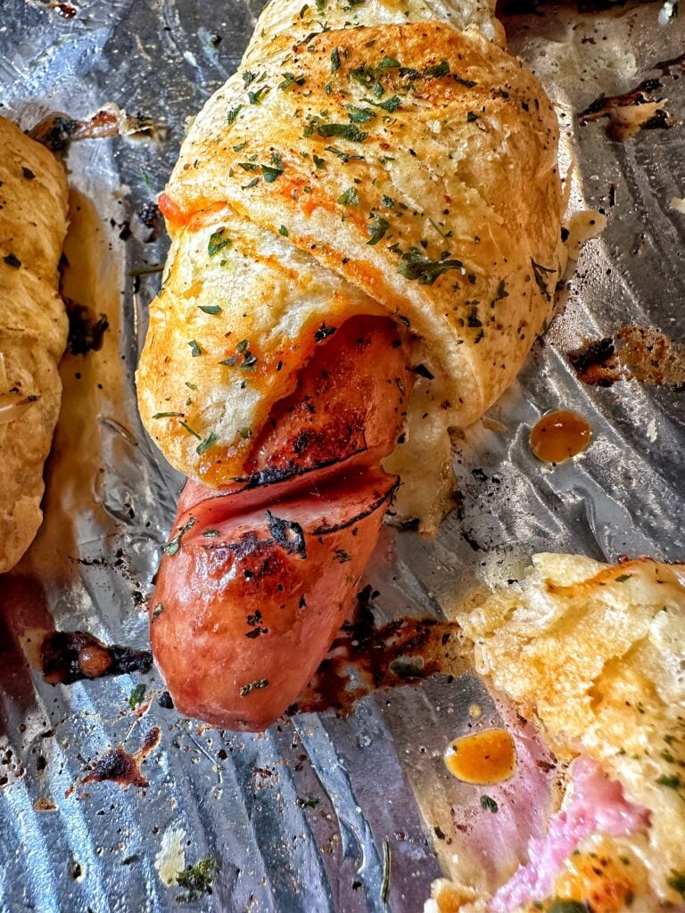 A close up of a frank and Swiss bite