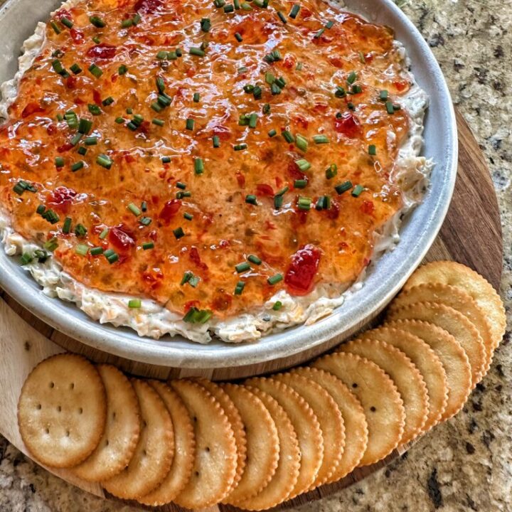 Pepper Jelly Cheese Dip with crackers laid out along the side