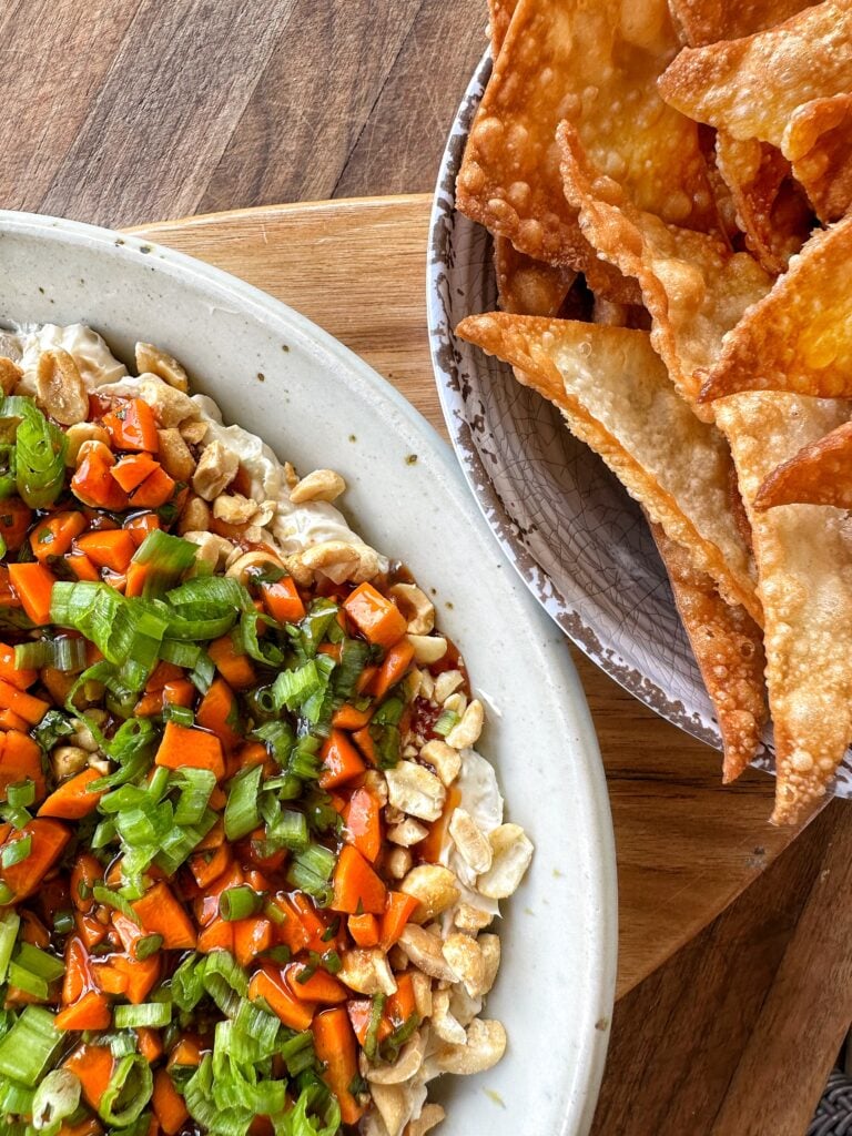 A close up of the egg roll dip and won ton chips